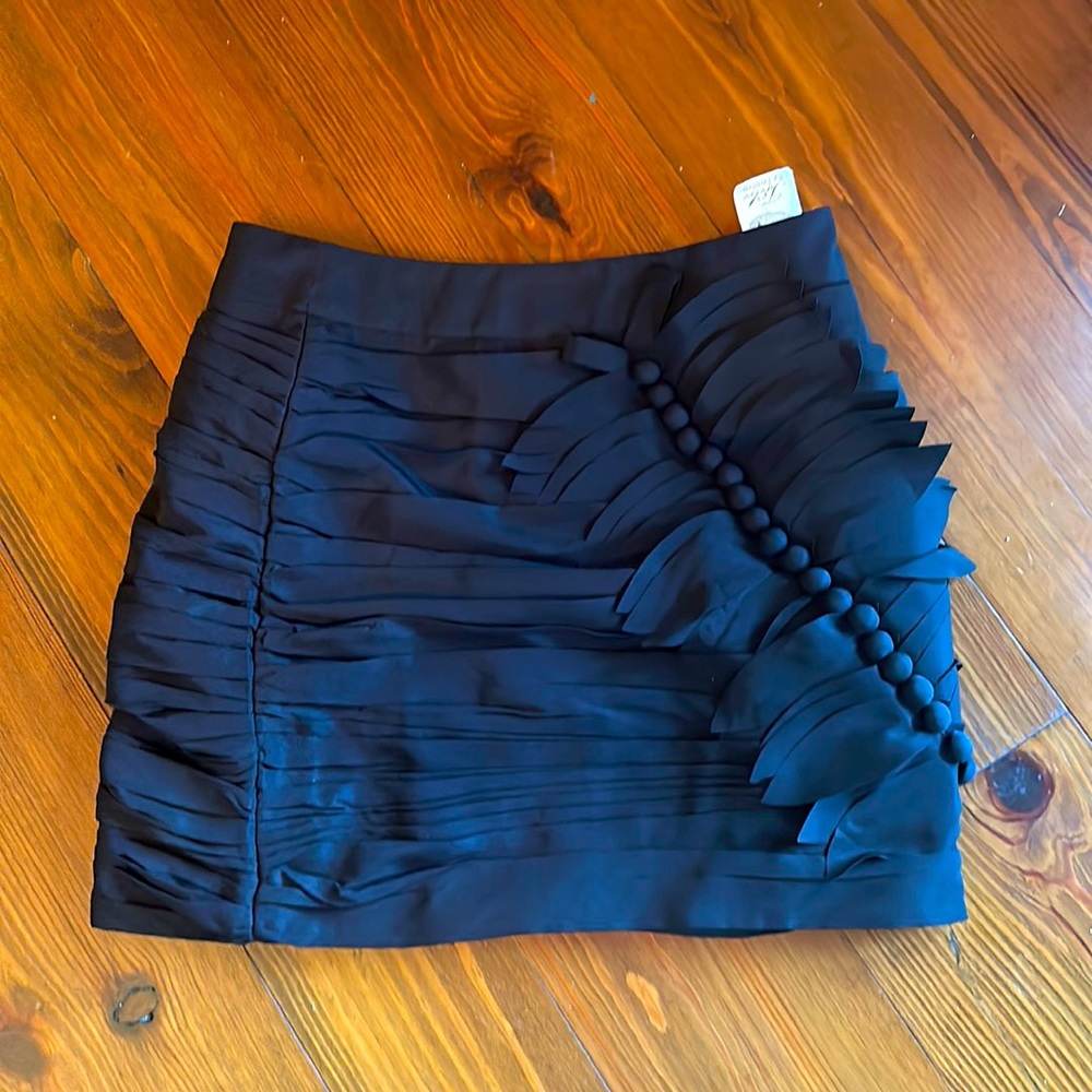 Twelve by twelve ski is the brand. It’s black mini skirt with a lot of texture.